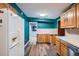 Traditional style kitchen with wood cabinets, view to a hall, and white appliances at 3026 Pinedale Ave, Lakeland, FL 33803