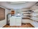 Functional laundry room with washer, dryer, water heater, and shelving at 3026 Pinedale Ave, Lakeland, FL 33803