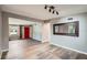 Spacious living room featuring hardwood floors, a large mirror, and a view of the kitchen at 3026 Pinedale Ave, Lakeland, FL 33803