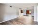 Open-concept living room featuring stylish hardwood floors and neutral wall colors at 3026 Pinedale Ave, Lakeland, FL 33803