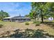 Backyard featuring a screened pool and lush green space, ideal for outdoor enjoyment at 3690 Sw 175Th St, Ocala, FL 34473