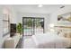 This bedroom features a white color scheme, a view of the pool, and a large television at 3690 Sw 175Th St, Ocala, FL 34473