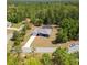 Scenic shot of a home boasting a screened lanai, with a private driveway and surrounded by mature landscaping at 3690 Sw 175Th St, Ocala, FL 34473