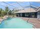 This screened-in pool features a waterfall rock feature, a covered patio, and a modern design at 3690 Sw 175Th St, Ocala, FL 34473