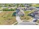 Aerial view of a single-Gathering home featuring a large lot, solar panels, a paved driveway and mature landscaping at 513 Kimbrel Ct, Haines City, FL 33844