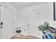 Bright and welcoming entryway with laminate floors, white walls, and a shoe rack with a 'Welcome-ish' sign at 513 Kimbrel Ct, Haines City, FL 33844