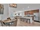 Open kitchen and dining area featuring a granite island, modern appliances, and stylish lighting at 513 Kimbrel Ct, Haines City, FL 33844