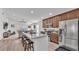 Modern kitchen with granite countertops, stainless steel appliances, island with seating, and open floorplan at 513 Kimbrel Ct, Haines City, FL 33844