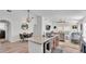 Open-concept kitchen with granite island, stainless steel appliances, and seamless flow to the living area at 513 Kimbrel Ct, Haines City, FL 33844