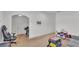 A Gathering living room with white walls, carpet, drums, grey couch, keyboard, toys, and chair at 513 Kimbrel Ct, Haines City, FL 33844