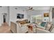Spacious living room with ceiling fan, ample natural light, and comfortable seating arrangements at 513 Kimbrel Ct, Haines City, FL 33844