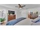 Bright main bedroom with ensuite bathroom and a view of a flat screen tv at 513 Kimbrel Ct, Haines City, FL 33844