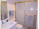 Bathroom with white vanity, toilet, and shower with sliding glass doors at 5225 Imperial Lakes Blvd # 52, Mulberry, FL 33860