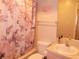 Cozy bathroom featuring a tub with a floral shower curtain and a mirrored vanity with a sink at 5225 Imperial Lakes Blvd # 52, Mulberry, FL 33860