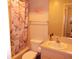 Cozy bathroom featuring a tub with a floral shower curtain and a mirrored vanity with a sink at 5225 Imperial Lakes Blvd # 52, Mulberry, FL 33860