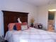 Bedroom with a dark-wood bedframe and access to the bathroom at 5225 Imperial Lakes Blvd # 52, Mulberry, FL 33860