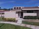 Inviting townhome with a cozy entrance, lush green lawn, and a tidy, well-lit walkway at 5225 Imperial Lakes Blvd # 52, Mulberry, FL 33860