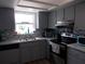 This kitchen features updated appliances, gray cabinets, and a mosaic backsplash at 5225 Imperial Lakes Blvd # 52, Mulberry, FL 33860
