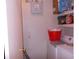 Functional laundry area equipped with a washing machine, dryer, and storage shelving for household supplies at 5225 Imperial Lakes Blvd # 52, Mulberry, FL 33860