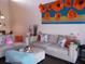 Cozy living room with plush sofas, decorative pillows, and artistic wall decor, perfect for relaxation at 5225 Imperial Lakes Blvd # 52, Mulberry, FL 33860