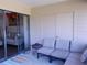 Enclosed outdoor patio with comfortable seating, sliding glass doors, and neutral-toned decor for relaxation at 5225 Imperial Lakes Blvd # 52, Mulberry, FL 33860