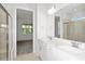 The luxurious bathroom features double sinks, a glass-enclosed shower, and elegant fixtures at 5844 Sw 87Th Ave, Ocala, FL 34481