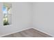 Bright bedroom featuring a window and light wood-look flooring and white trim at 5844 Sw 87Th Ave, Ocala, FL 34481