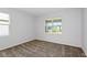 This carpeted bedroom features a sunlit window providing a glimpse of the outdoors at 5844 Sw 87Th Ave, Ocala, FL 34481