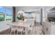 Bright dining room featuring a view to the kitchen, wood floors and natural light at 5844 Sw 87Th Ave, Ocala, FL 34481