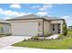 Charming single-story home featuring a two-car garage, landscaped yard, and neutral color palette at 5844 Sw 87Th Ave, Ocala, FL 34481