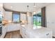 Bright kitchen featuring a large island, white cabinetry, and modern pendant lighting at 5844 Sw 87Th Ave, Ocala, FL 34481