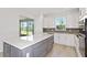 This spacious kitchen includes a large island, stainless steel appliances, and sliding doors to the backyard at 5844 Sw 87Th Ave, Ocala, FL 34481