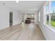 Open-concept living area showcasing luxury vinyl plank floors, lots of natural light, and seamless kitchen access at 5844 Sw 87Th Ave, Ocala, FL 34481