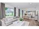 Spacious living room featuring an open floor plan and views of the backyard at 5844 Sw 87Th Ave, Ocala, FL 34481
