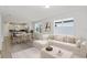 Bright open-concept living room showcases neutral decor, wood floors, and large windows at 5844 Sw 87Th Ave, Ocala, FL 34481