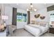 Relaxing main bedroom featuring lots of natural light, shiplap accent wall and stylish light fixture at 5844 Sw 87Th Ave, Ocala, FL 34481