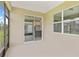 Covered patio with sliding glass doors offering view of kitchen and backyard at 5844 Sw 87Th Ave, Ocala, FL 34481