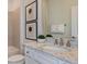 This bathroom features a granite countertop with double faucets, framed art, and decorative towels for a spa-like feel at 8199 Sw 52Nd Lane Rd, Ocala, FL 34481