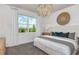 Comfortable bedroom showcases a decorative chandelier, ample natural light, and soft, neutral decor at 8199 Sw 52Nd Lane Rd, Ocala, FL 34481