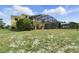 Backyard view of a screened-in pool and lush landscaping around the fence at 2523 Jasmine Trace Dr, Kissimmee, FL 34758
