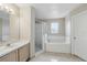 Bright bathroom featuring a shower, a soaking tub, and a large vanity with a sink at 2523 Jasmine Trace Dr, Kissimmee, FL 34758