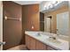 Full bathroom featuring a double sink vanity with spacious countertop and mirror at 2523 Jasmine Trace Dr, Kissimmee, FL 34758