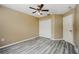 Bedroom features a ceiling fan, closet, neutral walls, and luxury vinyl plank flooring at 2523 Jasmine Trace Dr, Kissimmee, FL 34758