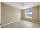 Bright bedroom with ceiling fan, light tan walls, and a window letting in natural light at 2523 Jasmine Trace Dr, Kissimmee, FL 34758