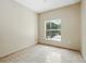 Bedroom features tiled floor and window view of screened lanai at 2523 Jasmine Trace Dr, Kissimmee, FL 34758
