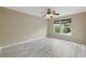 Spacious bedroom with large window, neutral paint, and light wood laminate flooring at 2523 Jasmine Trace Dr, Kissimmee, FL 34758