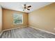 Bedroom features a ceiling fan, neutral walls, and luxury vinyl plank flooring at 2523 Jasmine Trace Dr, Kissimmee, FL 34758