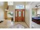 Grand foyer with soaring ceilings, beautiful tile flooring, and a decorative wood front door at 2523 Jasmine Trace Dr, Kissimmee, FL 34758