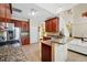 Kitchen featuring granite countertops, wooden cabinets, and stainless steel appliances at 2523 Jasmine Trace Dr, Kissimmee, FL 34758
