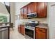 Kitchen with granite countertops, stainless steel appliances, and custom wood cabinetry at 2523 Jasmine Trace Dr, Kissimmee, FL 34758